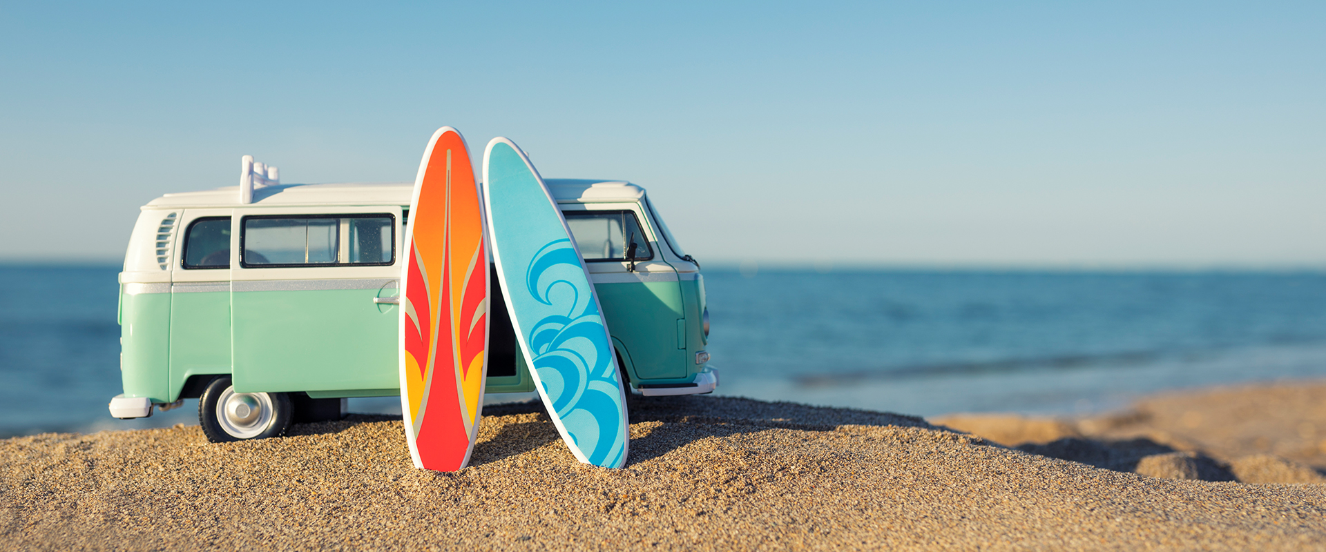 surfboards and van at beach